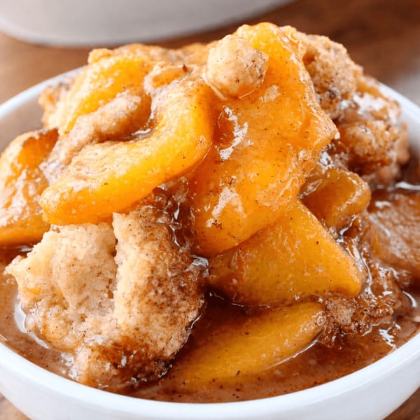 Close-up of Dan's Soul Food and Cafe's peach cobbler, with juicy peaches and golden-brown crust.